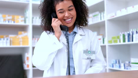 Happy-black-pharmacist-answering-a-phone
