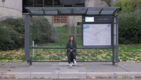 girl waiting bus at the city centre of luxembourg at fall season