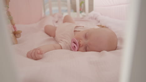 sleeping baby in pink crib