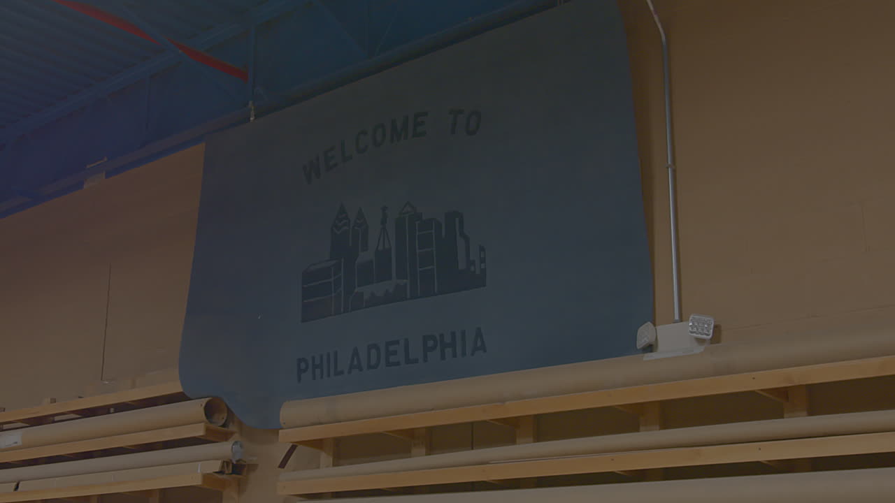 Sign featuring Philadelphia skyline welcomes trainees at carpenters union workshop