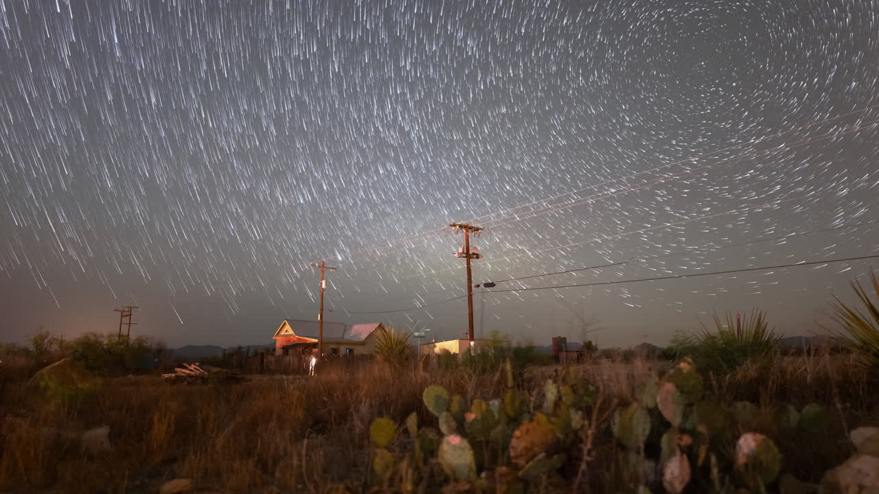 Stars trail in to comets drifting downwards over a west Texas landscape