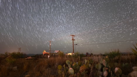 stars trail in to comets drifting downwards over a west texas landscape