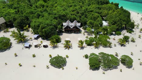 tropical bungalow condo on edge of palm tree forest at patawan island, balabac