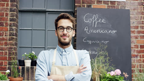 happy barista man portrait outside cafe