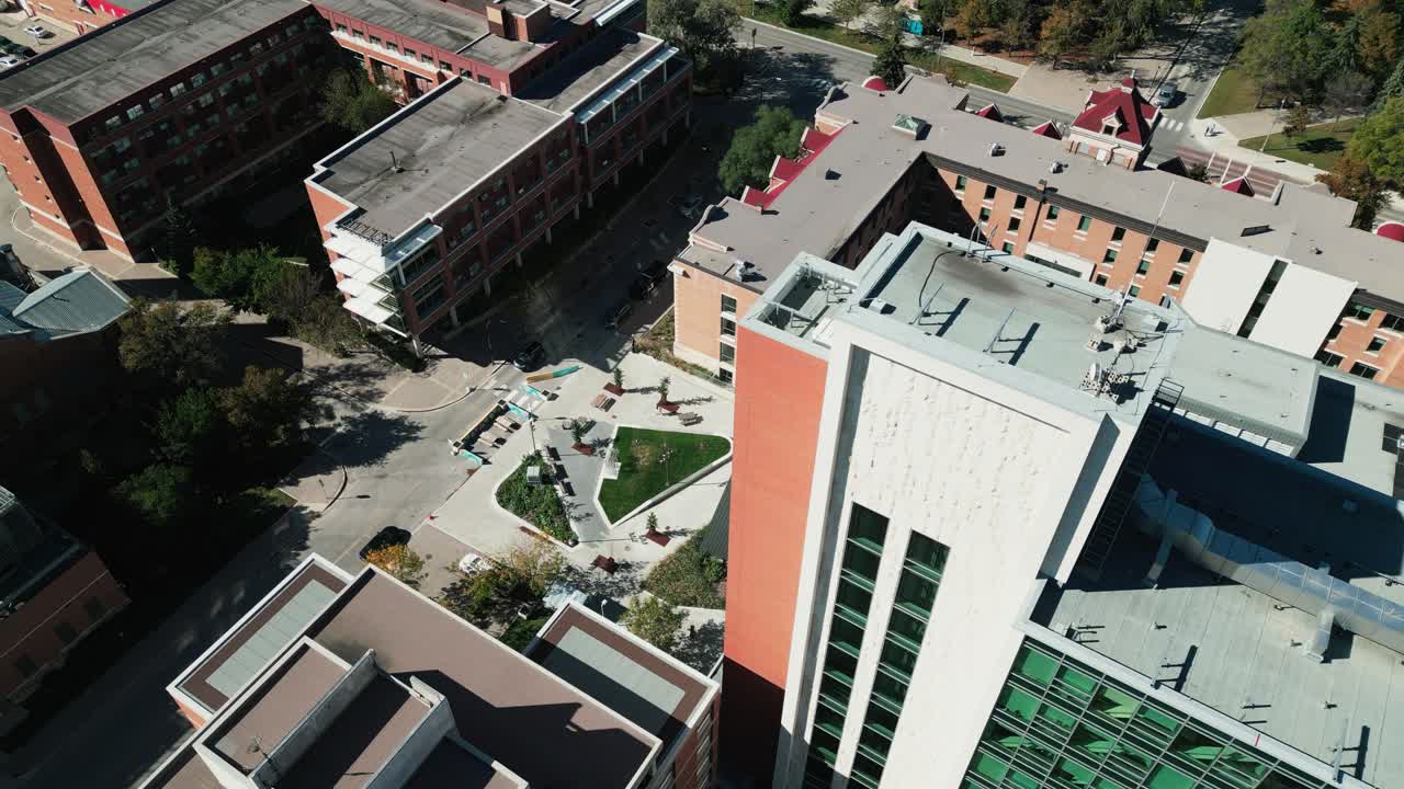 Drone captures Pembina Hall dorm courtyard with students walking outside