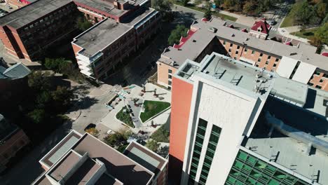 drone captures pembina hall dorm courtyard with students walking outside