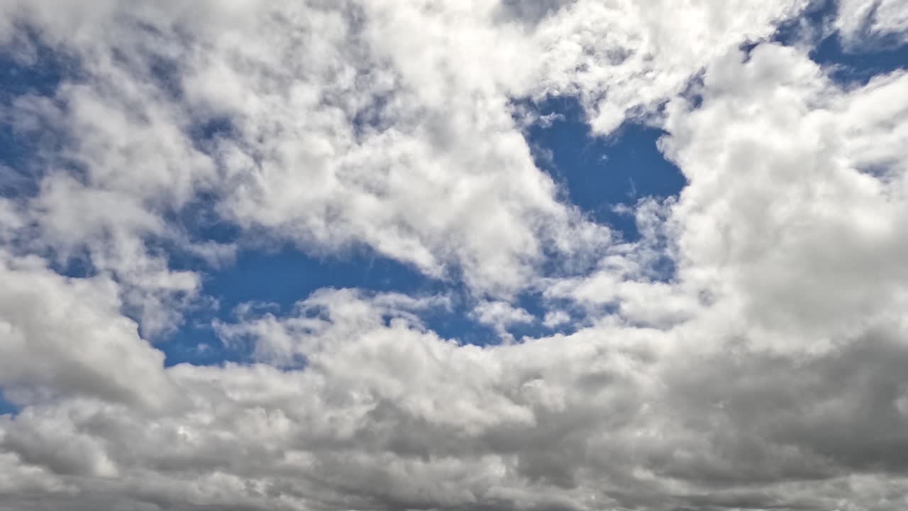 nubes cúmulosas moviéndose a través de un cielo azul