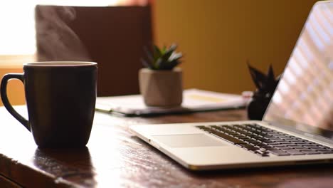 a cozy workspace featuring a steaming mug of coffee next to a laptop on a rustic desk, capturing the essence of a productive and inviting atmosphere