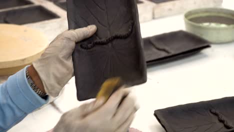 traditional pottery making, close up of potter's hands shaping a bowl on the spinning by clay