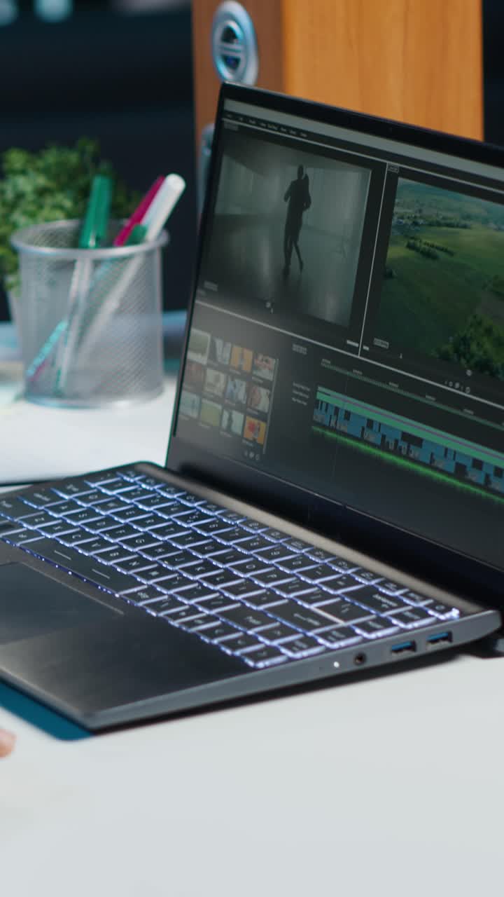 Vertical video Freelancer using editing tools on computer to cut movie project footage