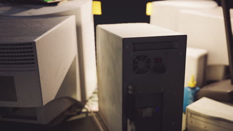 dimly lit workspace showcasing a computer tower and equipment