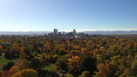 aerial view over city park denver and surrounding neighborhoods in fall autumn season, colorful trees and urban cityscape in horizon