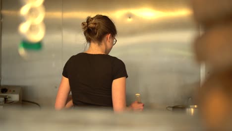 A-Woman-With-A-Bun-Working-In-The-Kitchen