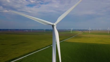 close up aerial view orbiting sustainable energy wind turbine on lafayette agricultural farmland, indiana countryside