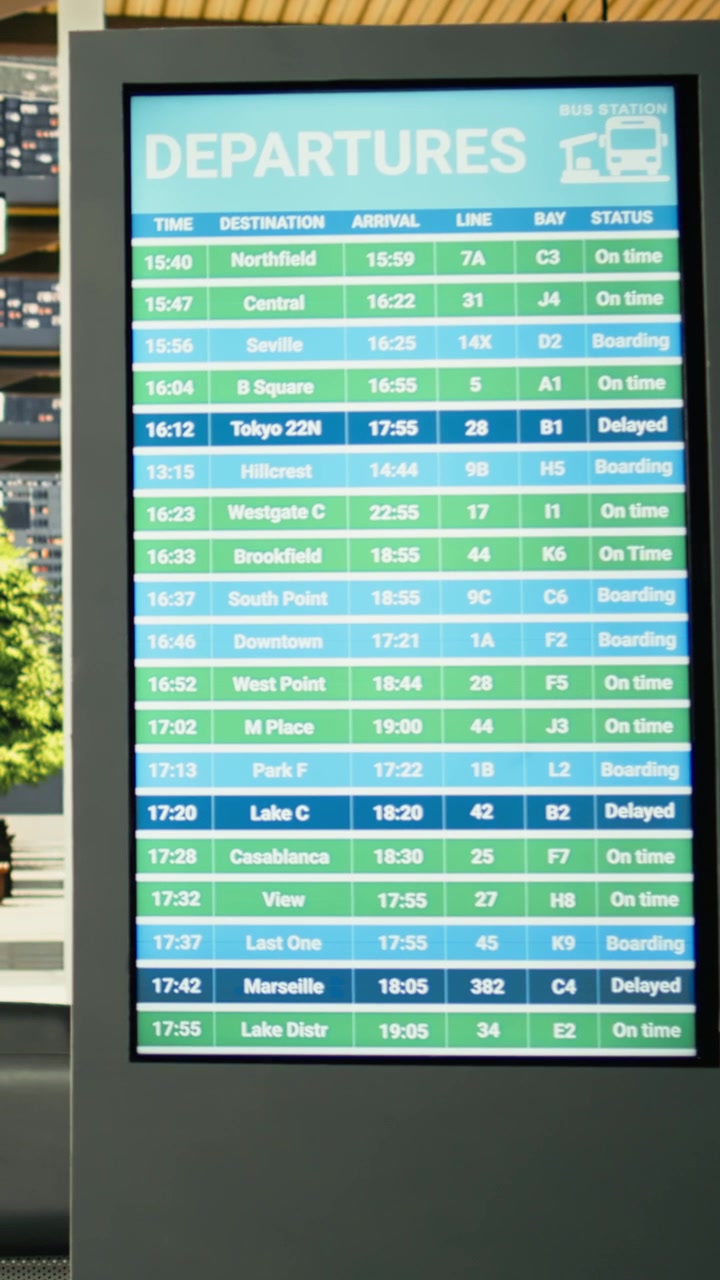 Contemporary coach station interior with empty seats and digital timetable