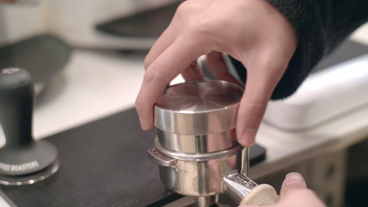 Portapress filter screw on lid compacts fresh coffee at cafe