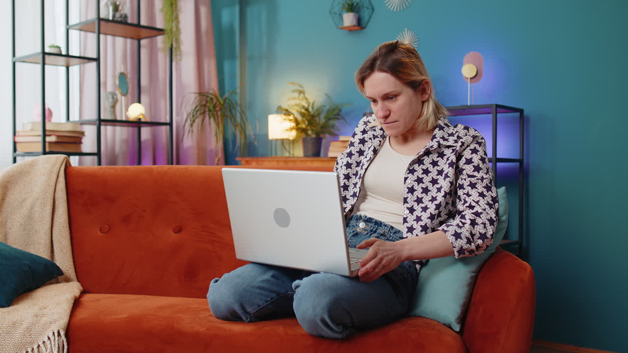 Sad woman using laptop notebook typing browsing working loses bad news game fail computer virus