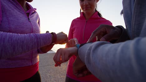 close up multi ethnic friends wrists checking pulse