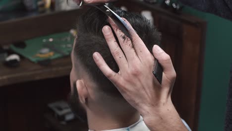 close-up of a man getting a haircut at a barbershop