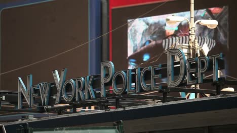 Traffic-passes-before-a-sign-for-the-New-York-Police-Department-in-New-York-City