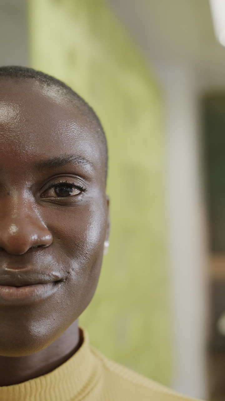 Vertical video of portrait of happy african american businesswoman in slow motion