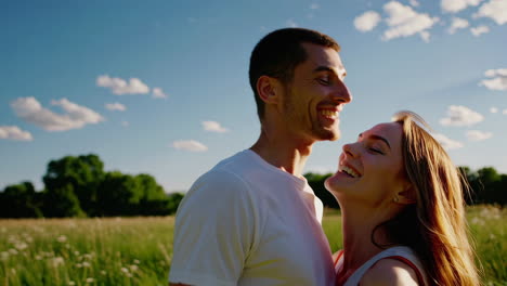 happy couple smiling outdoors in a sunny field