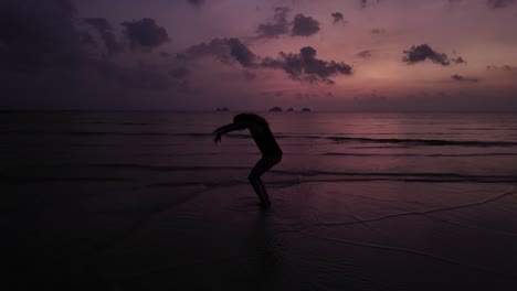 silhouette of a dancing woman at sunset on koh samui beach, thailand