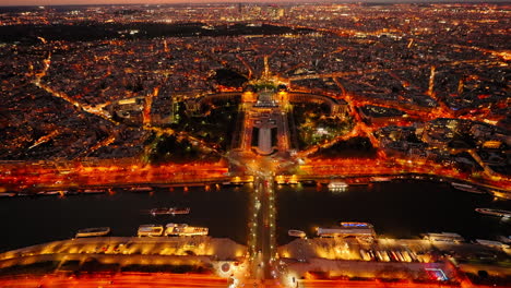 Blick-Vom-Eiffelturm-Auf-Die-Stadt-Paris,-Die-Nachts-Beleuchtet-Ist-Und-Von-Der-Seine-überquert-Wird