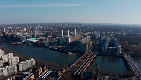 high circling drone shot around battersea power station on a beautiful sunny day