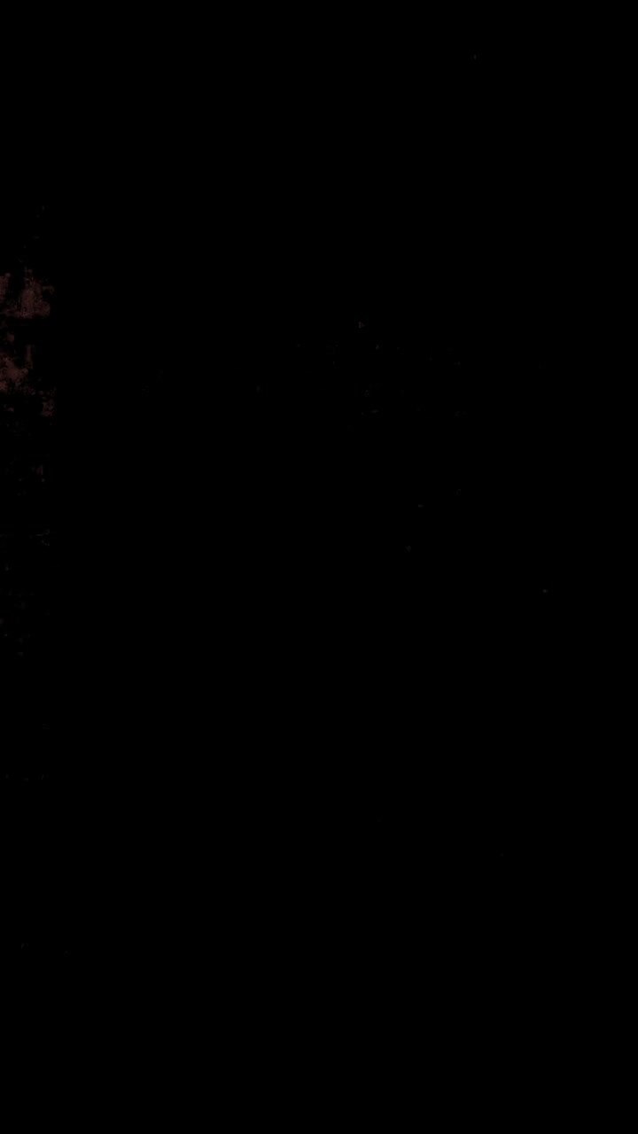 Close-up of a glowing dollar sign symbol in the dark
