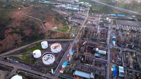 Aerial-orbiting-view-at-the-refinery-and-oil-storage-tanks,-Industrial-complex-in-Concón,-Chile