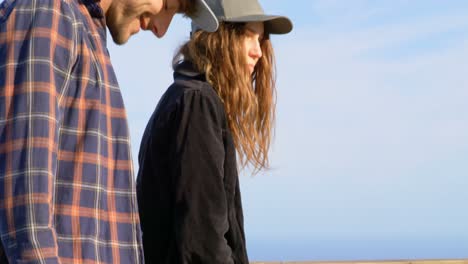 Side-view-of-young-caucasian-skateboarders-standing-with-skateboard-at-observation-point-4k