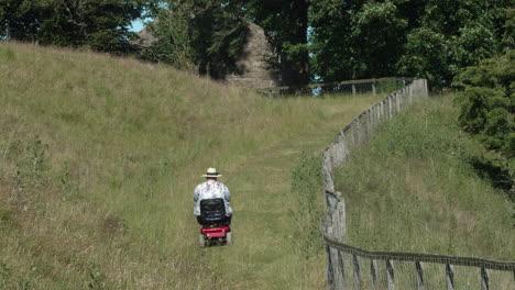 women on mobility scooter driving on footpath enjoying the countryside