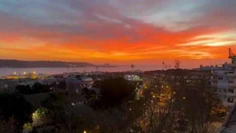 zoom-out-of-amazing-and-majestic-orange-sky-near-of-Justice-ministry-in-Lisbon-with-the-tagus-river-in-background