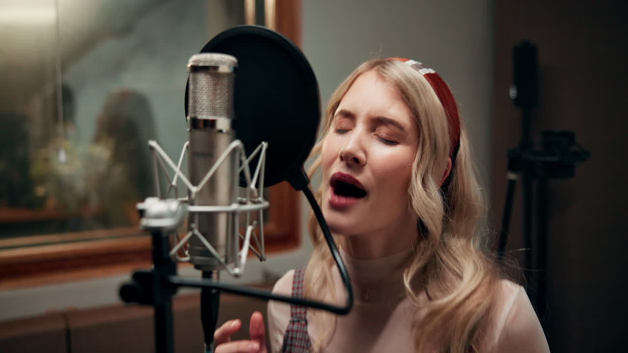 Singer recording a song in a studio