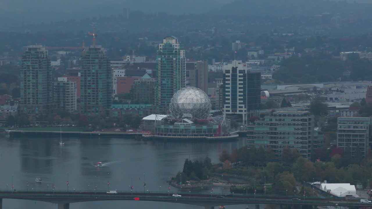 Telephoto panning aerial shot of Science World on a rainy afternoon in Vancouver, British Columbia, Canada. 4K