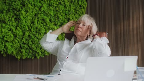stressed businesswoman relaxing at office desk