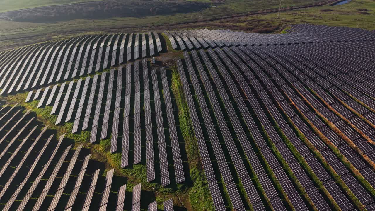 Solpaneler dækker et stort område på en mark under en klar himmel