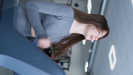 a beautiful young girl works out in the gym using dumbbells a beautiful young girl works out in the gym using dumbbells