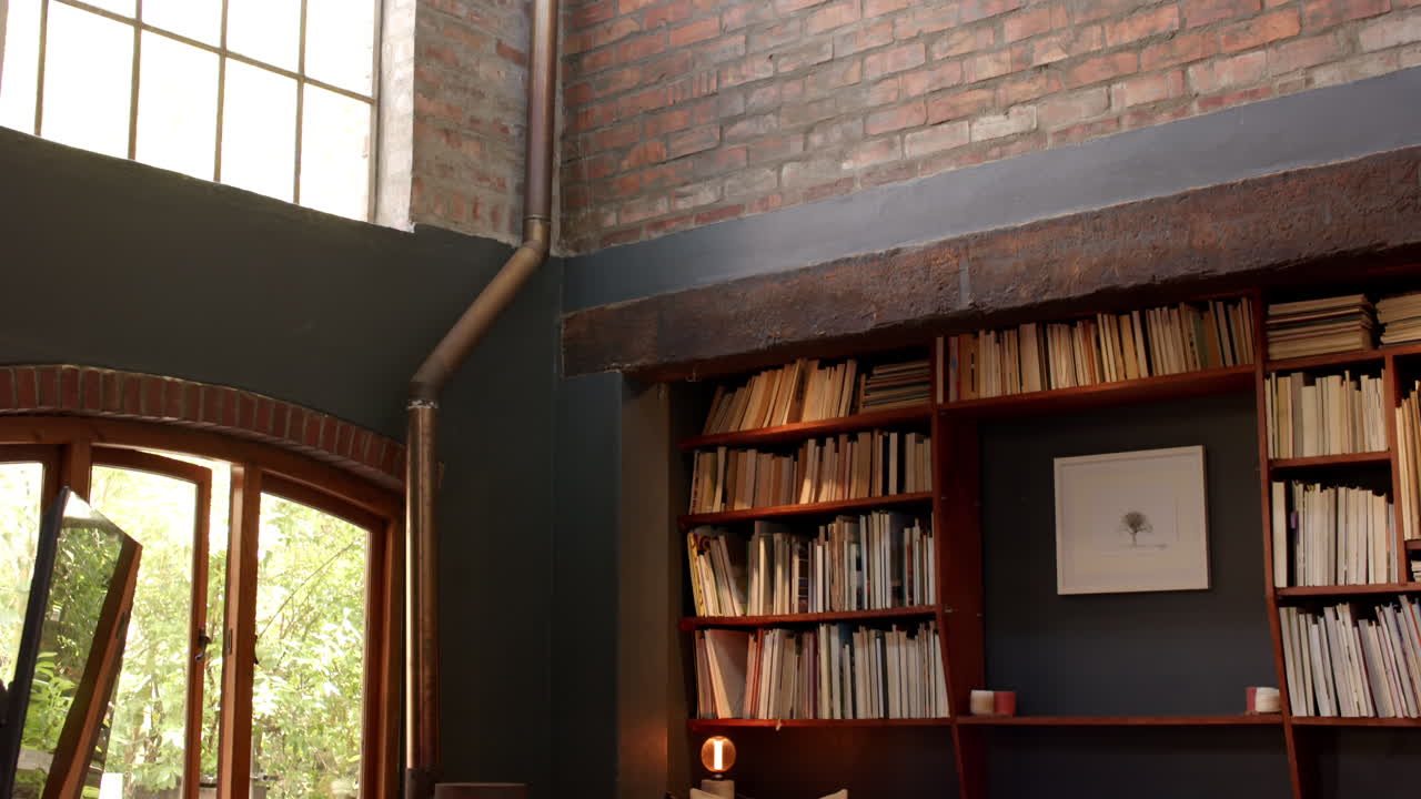 Cozy living room with bookshelves and window, perfect for relaxing and reading, at home