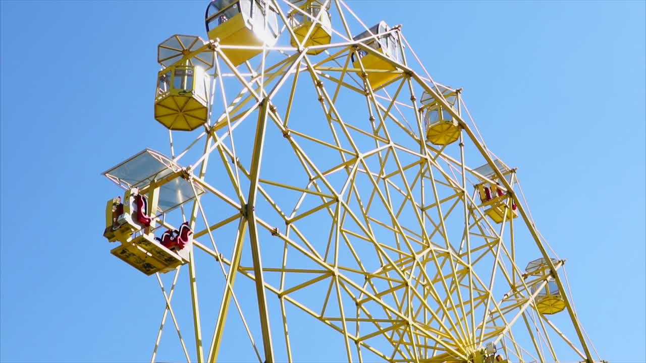 Yellow Ferris Wheel Against a Blue Sky