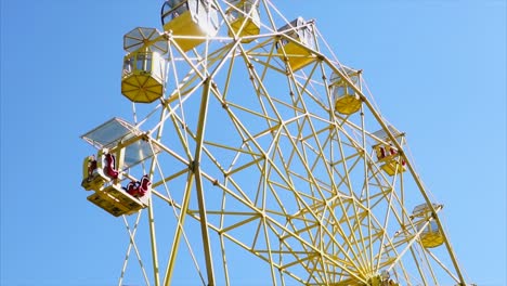 yellow ferris wheel against a blue sky