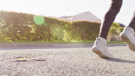 video of senior biracial man in sports clothes running on sunny street