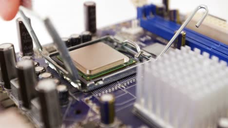 Technician-fixing-chip-on-motherboard