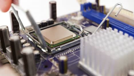 technician fixing chip on motherboard