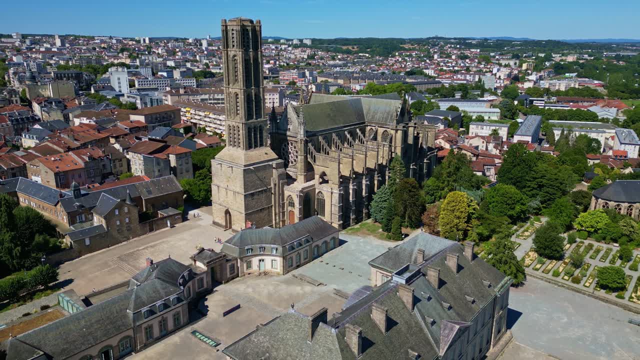 Smooth drone pullback unveiling the majestic Saint-Étienne Cathedral and the start of the elegant Bishop’s Garden, framed by lush greenery and the picturesque cityscape of Limoges - France