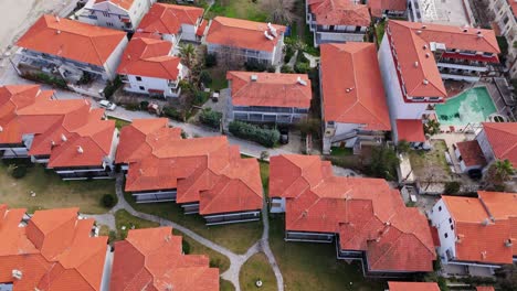 Top-down-aerial-view-of-tourist-resort-apartments-in-Pefkohori,-Greece