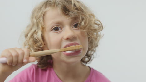 small girl brushing her teeth