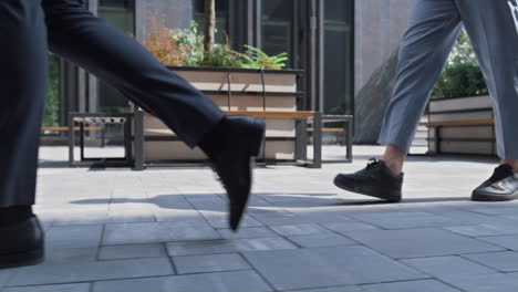 closeup corporate people legs walking downtown on sunny day. city lifestyle.