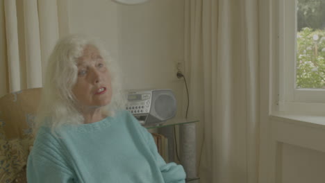 singing elderly woman rocking in a chair